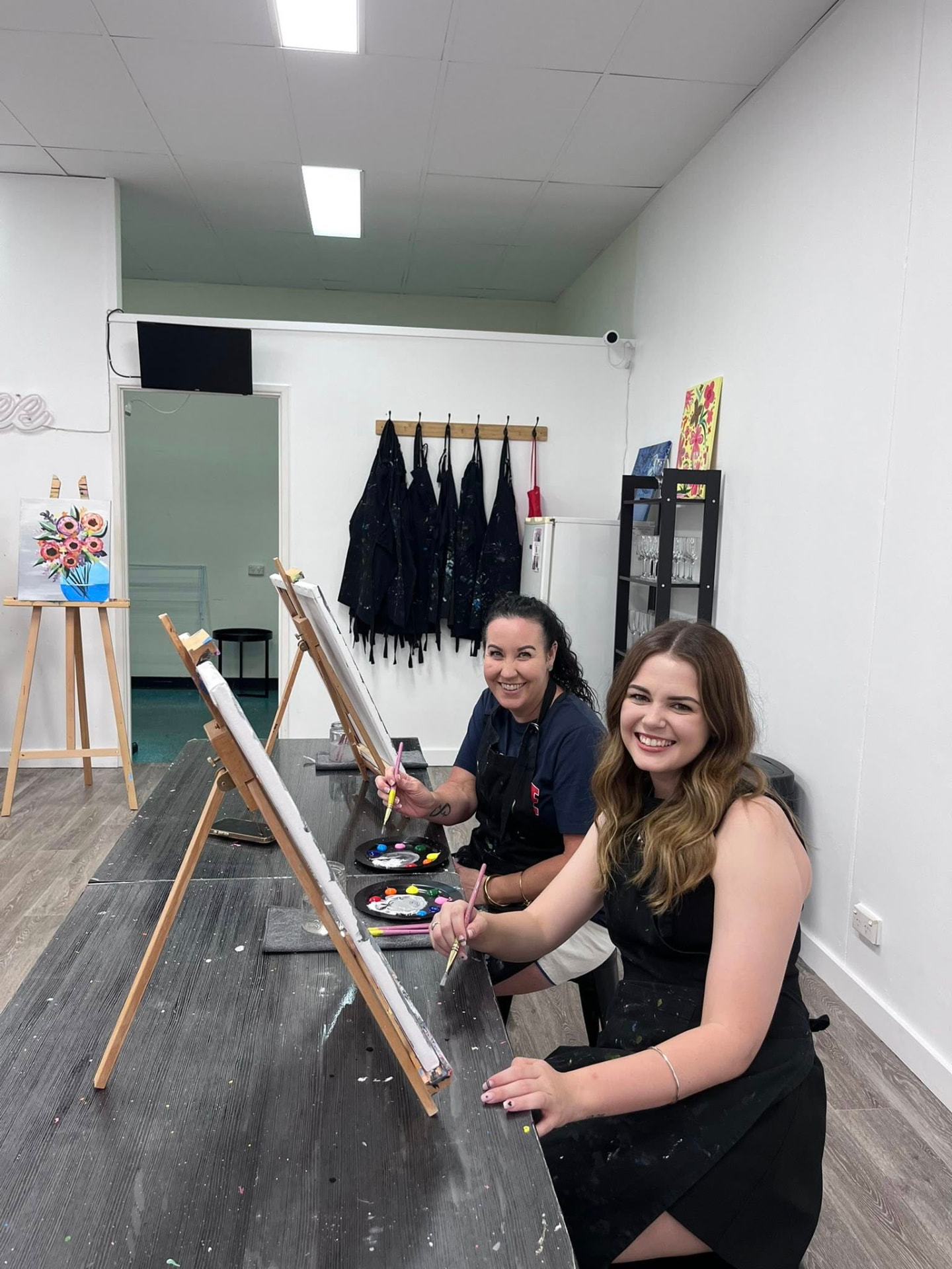Guests painting at easels