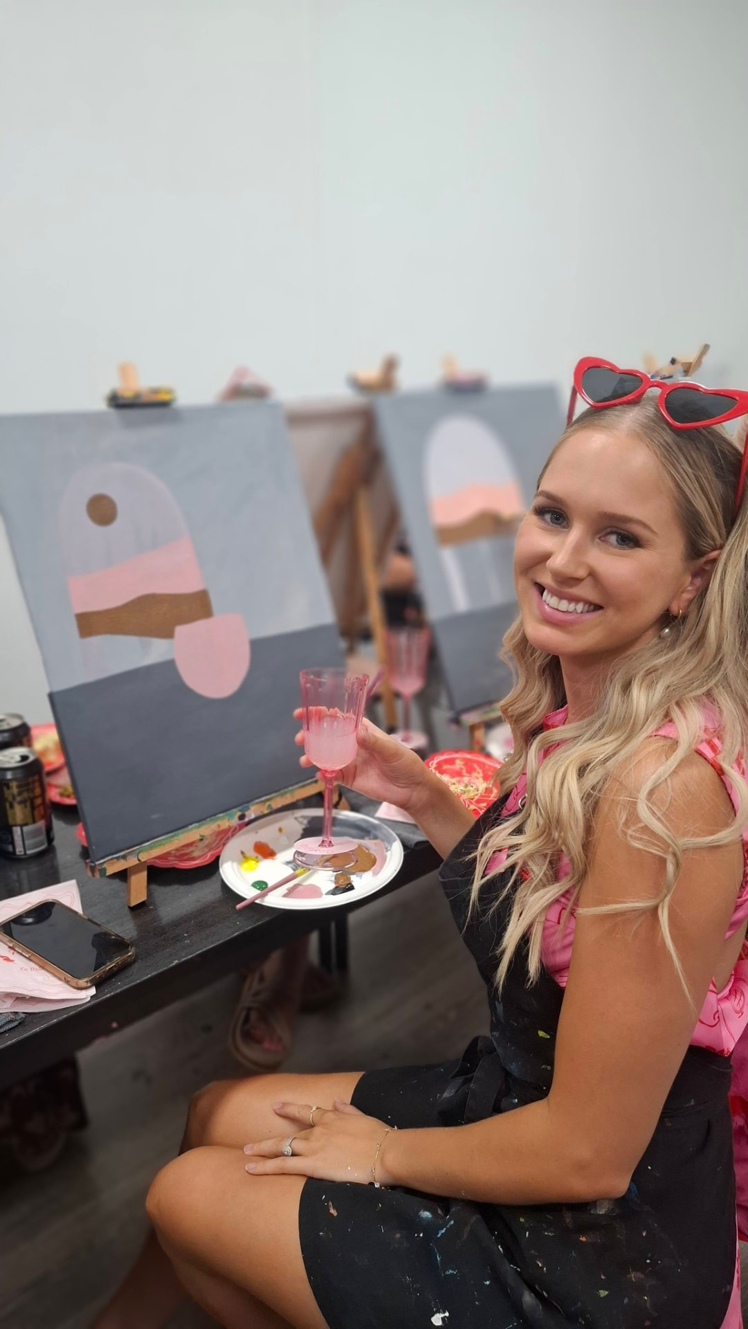 Guest posing with landscape painting